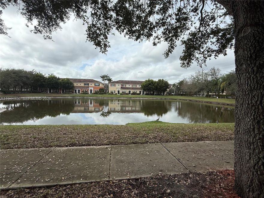 Spacious corner-unit 3-bedroom, 2.5-bath townhome with tranquil lake views, ideally located in the heart of Miramar. This well-maintained home offers a functional and open floor plan suitable for everyday living and entertaining. Features include an upgraded kitchen with granite countertops, stainless-steel appliances, ample cabinetry, and generous counter space. Ceramic tile flooring throughout the main living areas enhances durability, while newly installed carpet in the bedrooms adds comfort. The primary suite includes a private en-suite bath. Secondary bedrooms are well sized and versatile for guests or home office use. Washer and dryer included. A two-car covered garage is conveniently located behind the unit, providing secure parking and additional storage. Centrally located near The Shops at Pembroke Gardens, Pembroke Pines Mall, restaurants, parks, and entertainment, with easy access to major highways including I-75, Florida’s Turnpike, and I-95. Close to highly rated public and charter elementary and middle schools. Low HOA fees. Easy to show and vacate. Appointments available through ShowingTime. Community is well maintained with nearby walking paths and common areas.