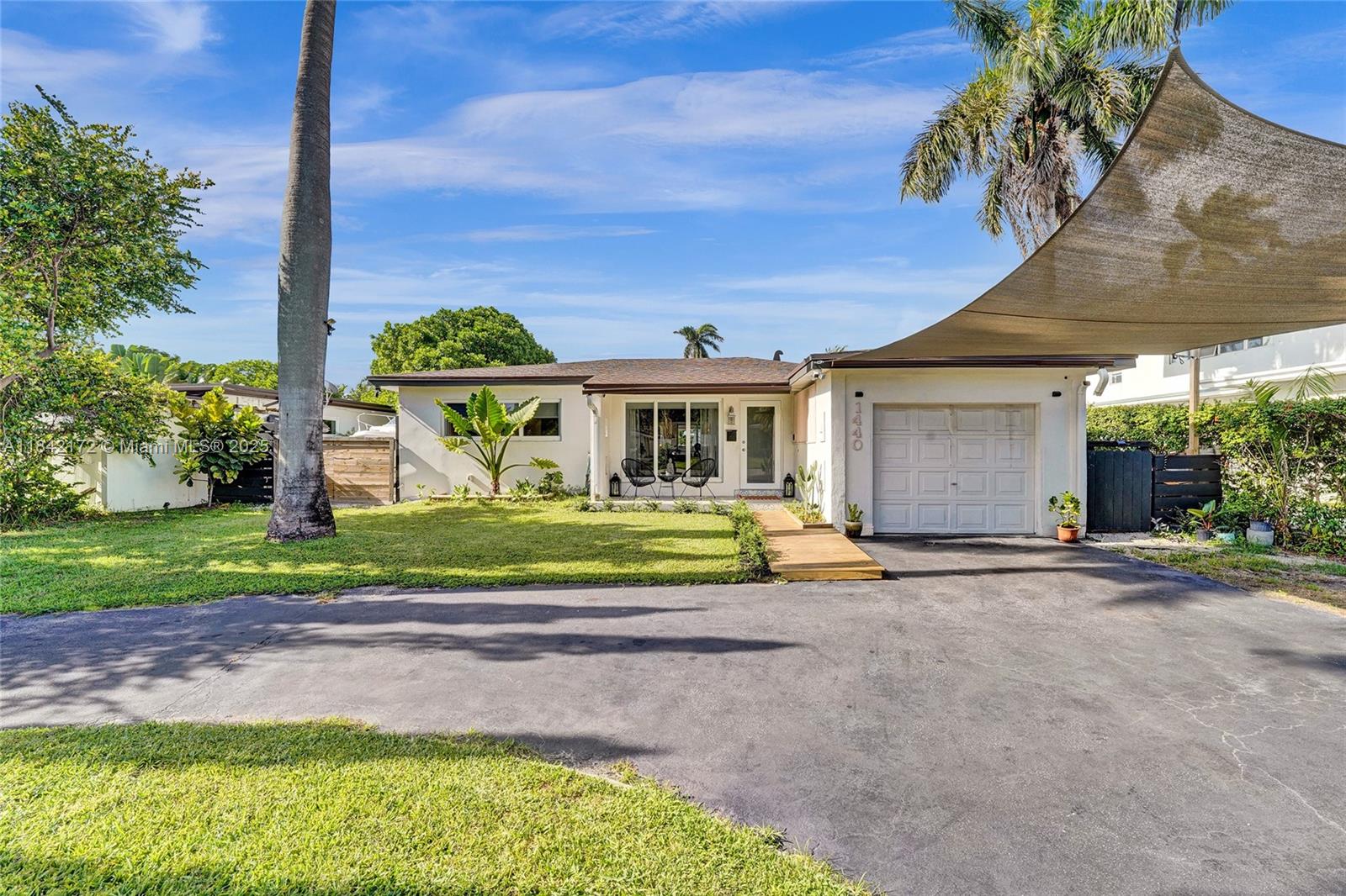 Bright & modern 2-bed, 2-bath pool home on an oversized lot! Updated kitchen w/ gas connection, quartz countertops, stainless appliances & large island—ideal for gatherings. Step outside to a 2023 salt-water pool w/ safety fence, covered patio, fenced yard w/ avocado & cotton candy berry trees. A circular driveway leads to gravel RV/boat space—perfect for recreation—plus electric car hookup, newer roof, tankless water heater & 3-ton A/C (˜1-yr). Inside, a decorative fireplace, water filtration, laundry, & 2 storage sheds. The partial garage conversion creates a flexible office space while leaving room for a golf cart. Located near Holland Park & Hollywood Beach Marina boat ramps, two golf courses & within walking and biking distance to the Hollywood Broadwalk & downtown!