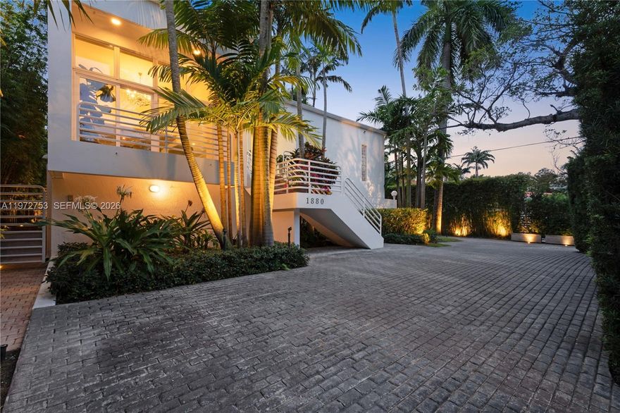 Perfectly positioned on iconic South Bayshore Drive, this private, gated residence offers an exceptional Coconut Grove lifestyle moments from Brickell. Adjacent to waterfront parks and scenic Bayfront paths, the location blends tranquility with easy access to Miami’s financial district, dining, marinas, and top schools. Set on a 9,000 SF lot, the property offers rare space and privacy. Mature landscaping enhances the seclusion, while natural light fills the interiors, bringing lush garden views indoors and highlighting tall ceilings. Updated in 2014, the home offers a timeless foundation to enjoy as is or elevate further. The third floor features the primary suite with walk-in closet and full bath, a second bedroom with full bath and balcony, and a laundry area. The second floor offers a generous bedroom suite. The ground level includes a full separate living quarter with private entry and kitchen, a full bedroom, plus a gym/flex room and additional laundry room—ideal for guests or extended family.
An oversized garage, off-street parking for up to 12 vehicles, and a dog park/play area complete the offering. The serene pool with fire pit and seating area provides a private oasis for relaxing or entertaining, while landscape lighting creates a beautiful evening ambiance. The pool is heated and saltwater.