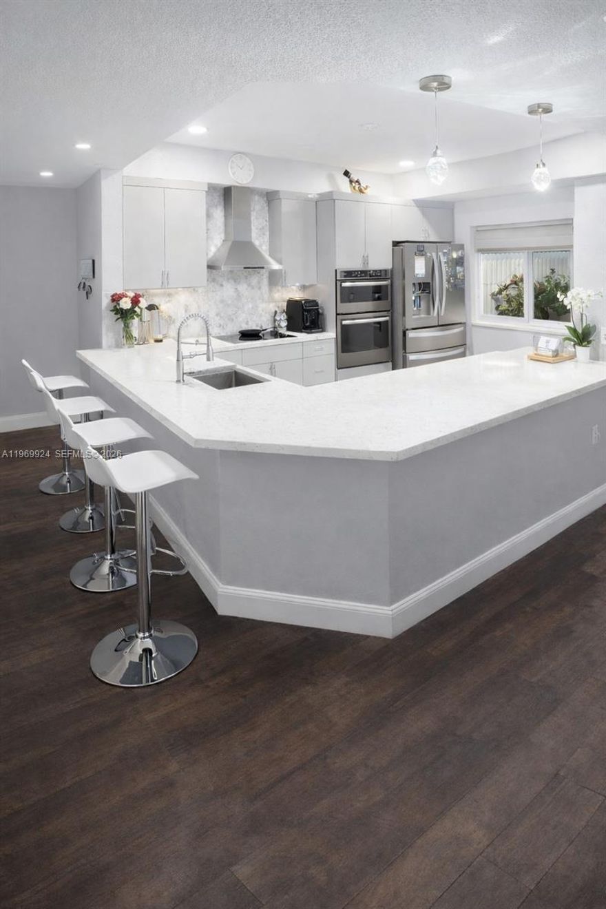 Turn key townhome a perfect blend of style and functionality, completlty remodeled, kitchen offers stone countertops, new appliances, incredibly spacious cabinets, also enjoy the confort of formal living room as well as formal dining room and florida room. Four bedrooms, two full bathroms and one-half bathroom. Master suite has an ensuite remodeled bathroom; three bedrooms are comfortably sized with ample closet space. One car garage, and a backyard. Important features include new roof and impact windows.