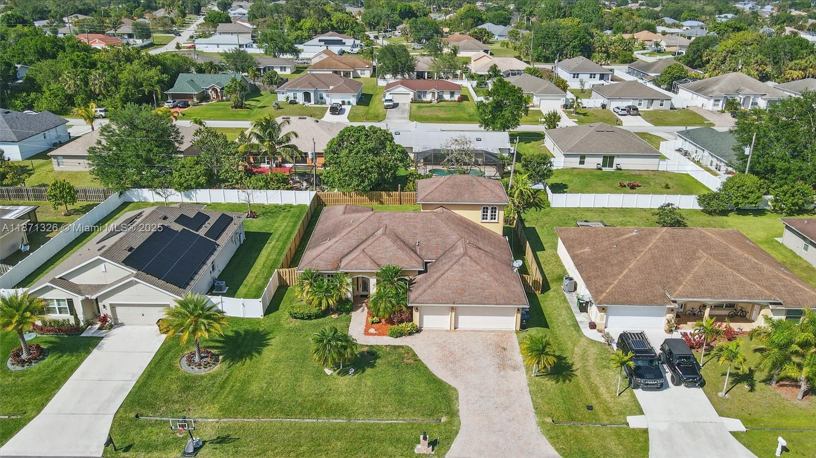 This beautifully designed home offers 5 spacious bedrooms and 3 bathrooms. Inside, you'll find a blend of diagonal tile and hardwood floors throughout. The gourmet kitchen features granite countertops, wood cabinetry, and newer stainless steel appliances. Elegant architectural touches, including double tray ceilings, arches, and crown molding, add a sophisticated charm. The large primary suite is a true retreat, with a jetted tub, tiled shower, and dual sinks. Upstairs, a generous bedroom provides versatile space, perfect for a loft, media room, or play area. Enjoy outdoor living with a massive fenced backyard, screened lanai, and extended paver patio. Conveniently located near shopping and local amenities. Don’t miss the opportunity to make this home yours!