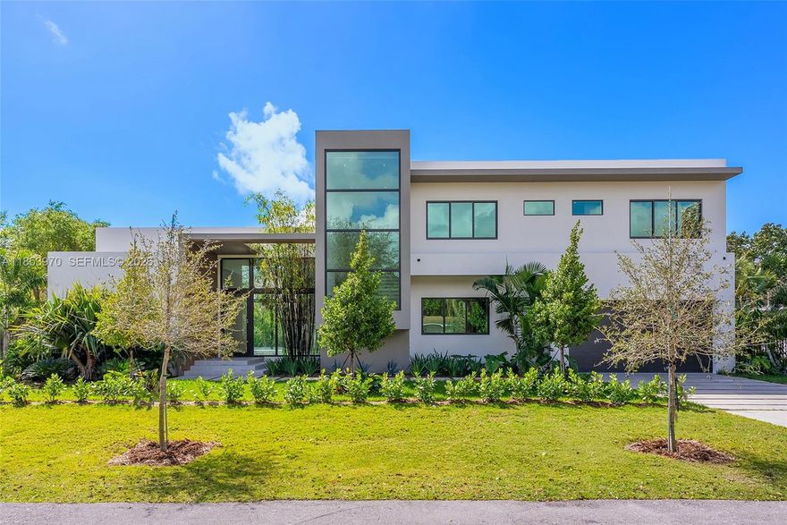 Introducing a distinguished new construction on a premier corner lot in the heart of Pinecrest, where timeless elegance meets modern design. This two-story residence features soaring ceilings, a grand entry, impact windows, custom Coblan cabinetry, and a chef’s kitchen with Miele appliances. The expansive great room opens to a sleek modern pool and covered terrace, perfect for entertaining. Two bedrooms on the main level, one with a private entrance, provide ideal accommodations for guests or multigenerational living. Upstairs, three en-suite bedrooms accompany a luxurious primary suite with a spa bath, oversized closet, and private terrace. A two-car garage and future-ready smart home integration complete this exceptional offering.