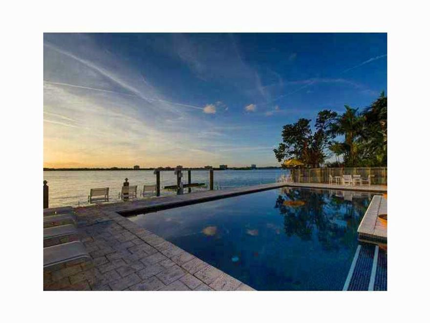 Just Reduced! Bring offers! The buyer can renovate the existing 6,904 sq ft house and create instant equity or demolish in order to build their dream home. It's a 5 bedrooms, 6.5 baths on the bay with dock and boat lift. Ceramic tile heated pool & huge co vered terrace overlooking the bay; covered outdoor kitchen area & pool bath. 3 car garage with maids bedroom & full bath. Courtyard entry, huge entry foyer with marble floors. Big kitchen equipped for kosher use. Huge master suite with spa bath.