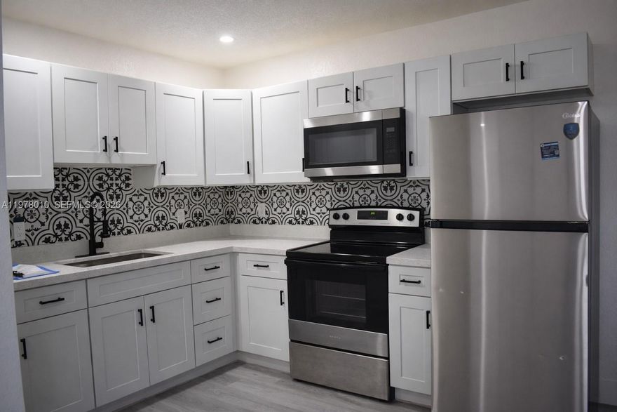 FAST APPROVAL!! READY TO MOVE IN. Beautifully updated 2-bedroom, 1-bath residence in the heart of Pompano Beach. This unit features impact windows, a newer roof and A/C, waterproof vinyl flooring throughout, fresh interior and exterior paint, new doors, baseboards, and blinds. The kitchen offers stainless steel appliances, including refrigerator, electric range, and microwave, along with a custom backsplash. Washer/dryer hookup inside the unit. Assigned parking included, with additional guest parking available. Fast approval!!! Conveniently located near ALDI, Pompano Citi Centre, Publix, dining, and major roadways for easy commuting. AVAILABLE FOR SHOWINGS!!