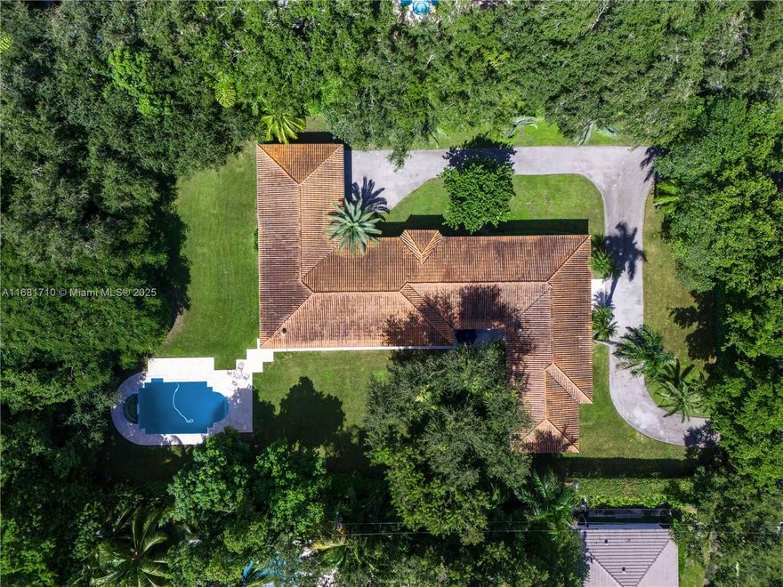 Enjoy a luxurious lifestyle in the prestigious Platinum Triangle of Coral Gables, one of the most exclusive sections of The City Beautiful surrounded by beautifully tree lined streets and lush yet meticulously landscaped estates. This 4 bedroom | 4-1/2 bathroom pool home of over 5,000 sq.ft. of living area sits on approximately a builder's acre. The layout of this estate is focused on elegant living and entertaining with a classic floorplan that features a welcoming foyer, and a large formal living room filled with natural light. The formal dining room will make you proud to invite friends for an evening of fine dining followed by relaxation in the cozy family room or in your huge covered terrace overlooking the large lawn and pool. Come see this gem and see how you can make it YOUR home!