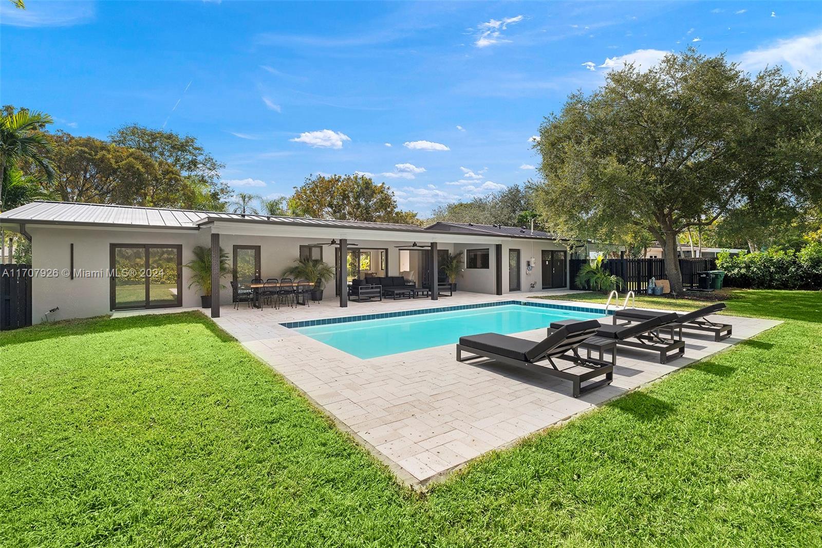 Discover this fully remodeled masterpiece w 2,011 ADJ SQFT LA in Pinecrest! Everything is NEW: roof (10-year wty), electrical, plumbing, insulation, impact windows, modern bathrooms, kitchen w new Samsung appliances, & thoughtfully designed floor plan. Situated on a spacious 16,770 sq ft lot, steps from Pinecrest's top-rated schools. The home features a modern living/dining area w covered terrace access, luxurious master suite with built-in walk-in closet, junior suite w private bathroom & walk in closet w garden views, & 2 Jack & Jill bedrooms (1 of the bedrooms is currently open to the living room and could be used as office or tv room). Lush landscaping, irrigation system, & carport for 2 cars. Move into high-end living without the hassle of construction—an unparalleled opportunity.