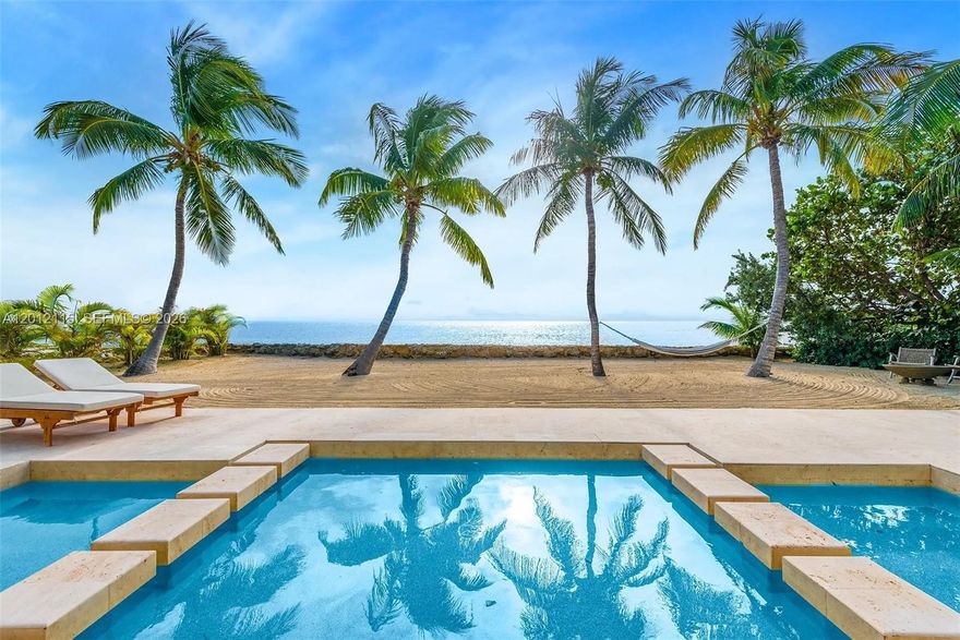Experience coastal luxury at The Oasis, a striking oceanfront sanctuary with 86 feet of direct Atlantic frontage nestled within the most exclusive area of Key Largo. Designed to blur the lines between indoors and out, this 3-bedroom/3-bathroom stunning residence spans approximately 2,500 square feet and features floor-to-ceiling windows that flood interiors with natural light, while an open-concept layout connects elegant living spaces to expansive terraces overlooking the ocean. 
Resort style amenities are highlighted by a 75-foot infinity-edge pool stretching toward the horizon, creating a breathtaking centerpiece for relaxation and entertaining. The property’s lush tropical landscaping, covered patio, and outdoor gas-powered kitchen make it ideal for hosting gatherings or enjoying breathtaking panoramic ocean views and quiet moments by the sea. Built with solid concrete construction, impact glass, and a metal roof, the home offers lasting peace of mind in a coastal environment. Perfectly positioned in one of Key Largo’s most desirable enclaves, and minutes from fine dining, marinas, and boutique shopping, The Oasis delivers an unmatched combination of style, serenity, and elegant oceanfront living. Conceptual architectural expansion plans are available for an additional 4-bedrooms/2-bathrooms along with documentation for the addition of a 150 ft. private dock. See due diligence for more information.