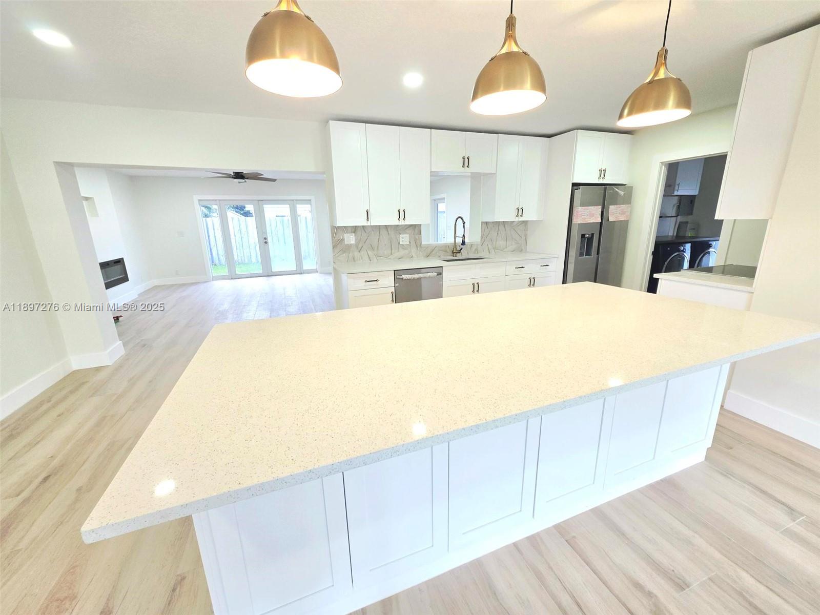 Completely Renovated and Move-in Ready 3/2 Single Family Home with No HOA!! Open Concept / Floor plan with a Wood-like Tile Floor Planks throughout the entire home - large Kitchen Island, Beautiful Pendant Lighting, Shaker Style Cabinets, Stainless Steel Appliances, Quartz Counter Tops, and Wine Cooler - Large Great Room with a Beautiful 6 Foot Recessed Fireplace and Room for a Large Wall Mount TV on Top - Beautiful and Spacious Master Suite with Walk-in Closets ($3200 Credit for Custom Closets), Small sitting room or room for a treadmill / workout space or kitchenette, Spacious Master Bath with Double Sink and a large Rainfall Shower - Covered Patio with a built-in BBQ Grill and Sink - Whole House Generator - Tankless Water heater - 3 Minutes to Pine Crest & Westminster Private Schools
