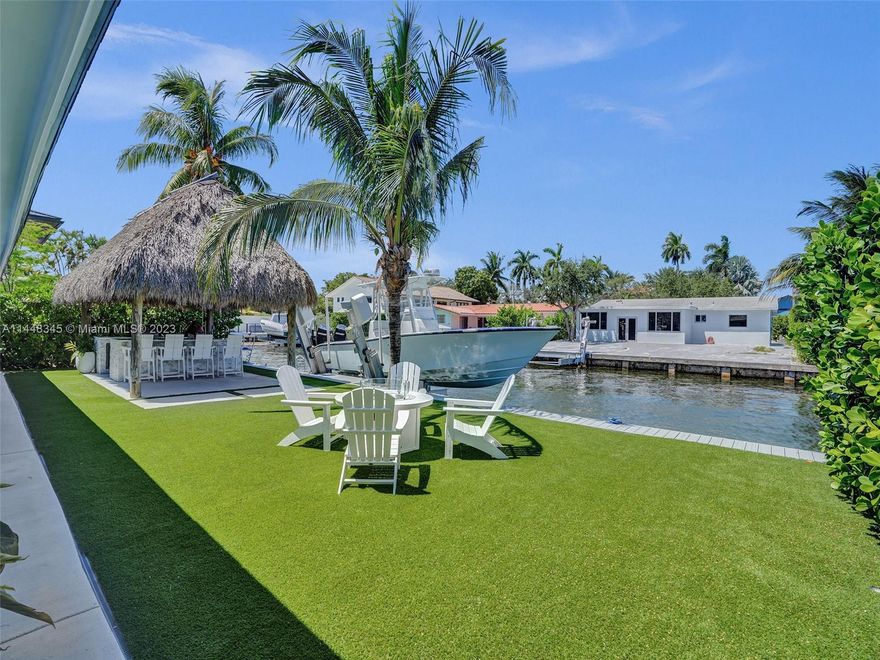 STUNNING WATERFRONT MID-CENTURY MODERN HOME IN MIAMI'S PRESTIGIOUS UPPER EAST SIDE."COMPLETELY RENOVATED". BOASTS 65 FEET OF  PRIME WATERFRONT. OCEAN ACCESS NO FIXED BRIDGES. LARGE OPEN GOURMET KITCHEN WITH QUARTZ COUNTER TOPS EQUIPPED WITH TOP-OF-THE-LINE APPLIANCES AND FINISHES MAKING IT A CHEF'S DREAM COME TRUE. SLIDING WALL OF GLASS BLEND TOGETHER INDOOR AND OUTDOOR LIVING SPACES. SPECTACULAR PRIMARY BEDROOM WITH SPA-LIKE BATHROOM, 3 BED / 2 BATH,2 CAR GARAGE.2,656 SQUARE FEET TOTAL: FEATURES INCLUDE IMPACT WINDOW'S / DOORS,BOATERS DREAM DOCK AND BOAT LIFT, "TIKI HUT" WITH OUTDOOR FULL SUMMER KITCHEN, Room for a pool, NUMEROUS LIVING AREAS CREATES AN ENCHANTING SETTING DESIGNED TO BRING FAMILY + FRIENDS TOGETHER FOR THE ULTIMATE IN PRIVACY AND MODERN LUXURY LIVING.