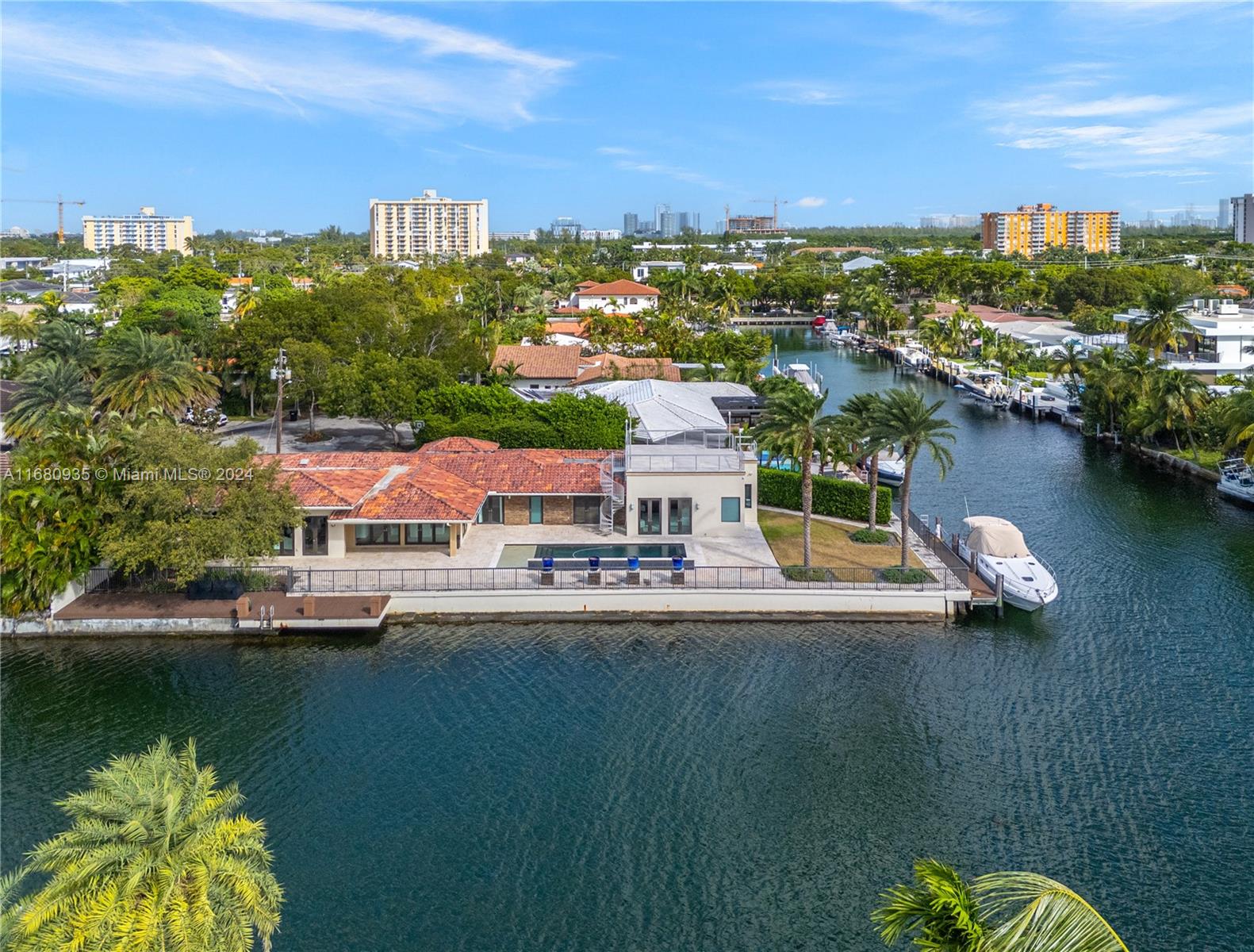 Discover the charm of Keystone Point. With over 180+ feet of frontage and no fixed bridges to the open water, this Single-story home is a boater's paradise. Situated on a sprawling corner lot, the property has a peaceful feeling as there is tropical landscaping, an oversized dock, and a stunning pool. This waterfront home offers four bedrooms, 4 1/2 baths, and a spacious 2-car garage, perfectly positioned just 10 minutes from the beach! The open floor plan fills the oversized living area and kitchen with natural light. French doors create a seamless connection to the outdoors. Whether you're looking to relax or customize your space, this home offers endless possibilities for a true Florida lifestyle retreat. This home will not last long. Please call the Listing Agent for showings.