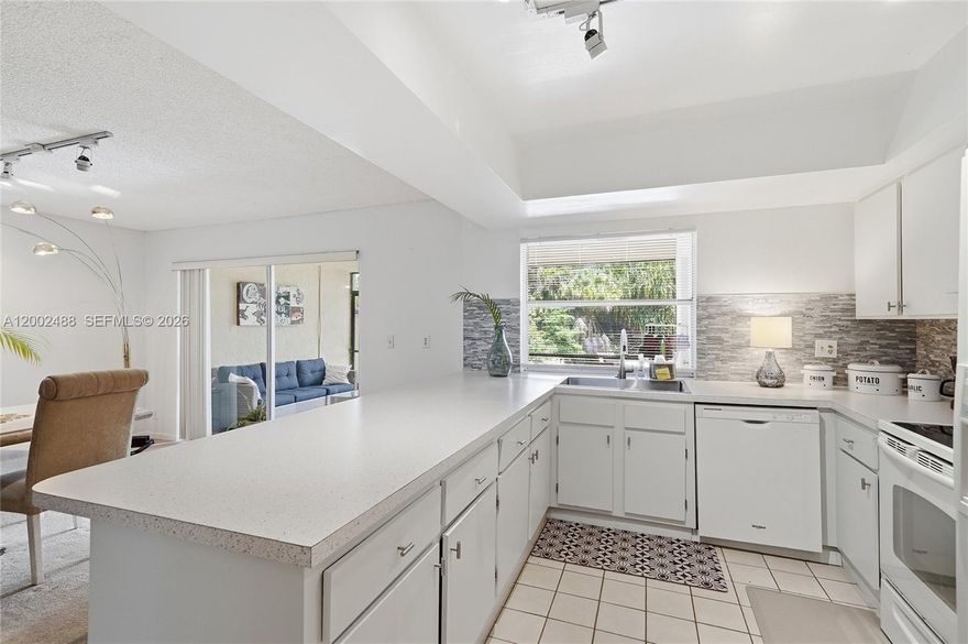 Spacious and versatile 3 bedroom, 3 bathroom first floor residence offering a bright, open layout and incredible potential to create your dream home. This light-filled unit features a welcoming front entrance, a formal dining area, and a unique sunken family room that is perfect for relaxing or entertaining. A full bathroom on the first floor adds flexibility for guests or multi-generational living.
The oversized kitchen offers abundant counter space along with two pantry closets, ideal for storage and functionality. Upstairs, the expansive primary suite includes a private sitting area and access to a large balcony, creating a perfect retreat. Laundry is conveniently located on the second floor.
Enjoy a peaceful and private backyard with a large screened-in patio and lanai that's ideal for outdoor living year-round. The home also features an updated electrical panel and a new roof currently being installed. Maintenance includes water, landscaping, and exterior building insurance. The 40-year inspection has been completed. Conveniently located near schools, shopping, and major roadways, offering easy access for daily living. A fantastic opportunity for a growing family to customize and make it truly their own.