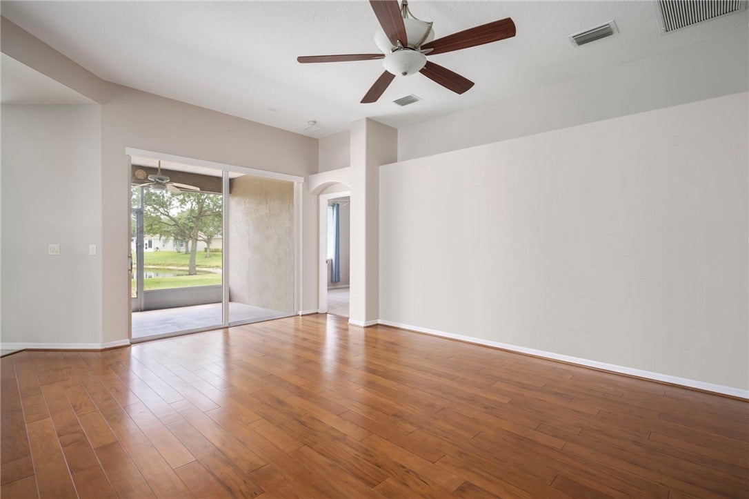 Entryway featuring wood-finish flooring, recessed lighting, and a paneled front door with a decorative glass sidelight