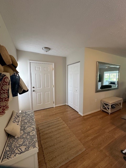 Entryway featuring wood-finish flooring, a flush-m