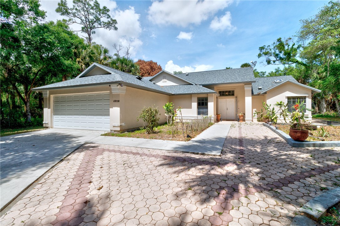 Ranch-style home featuring stucco siding, an attac