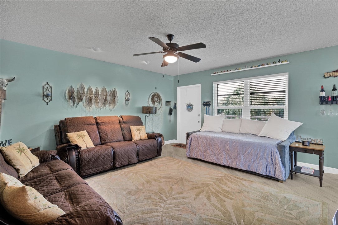 Spacious living area featuring light blue walls, a