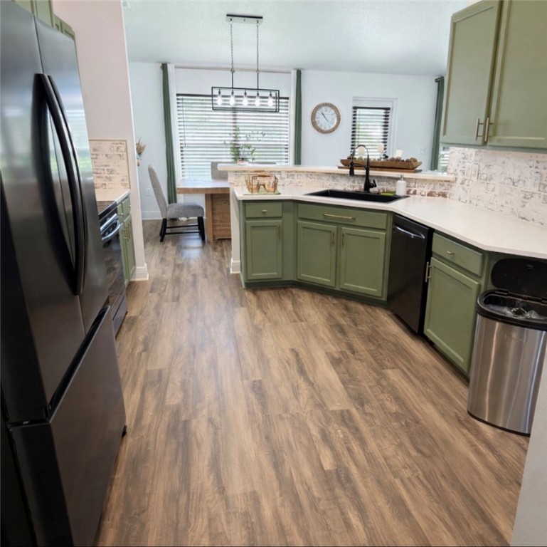 Kitchen featuring green cabinets, freestanding ref