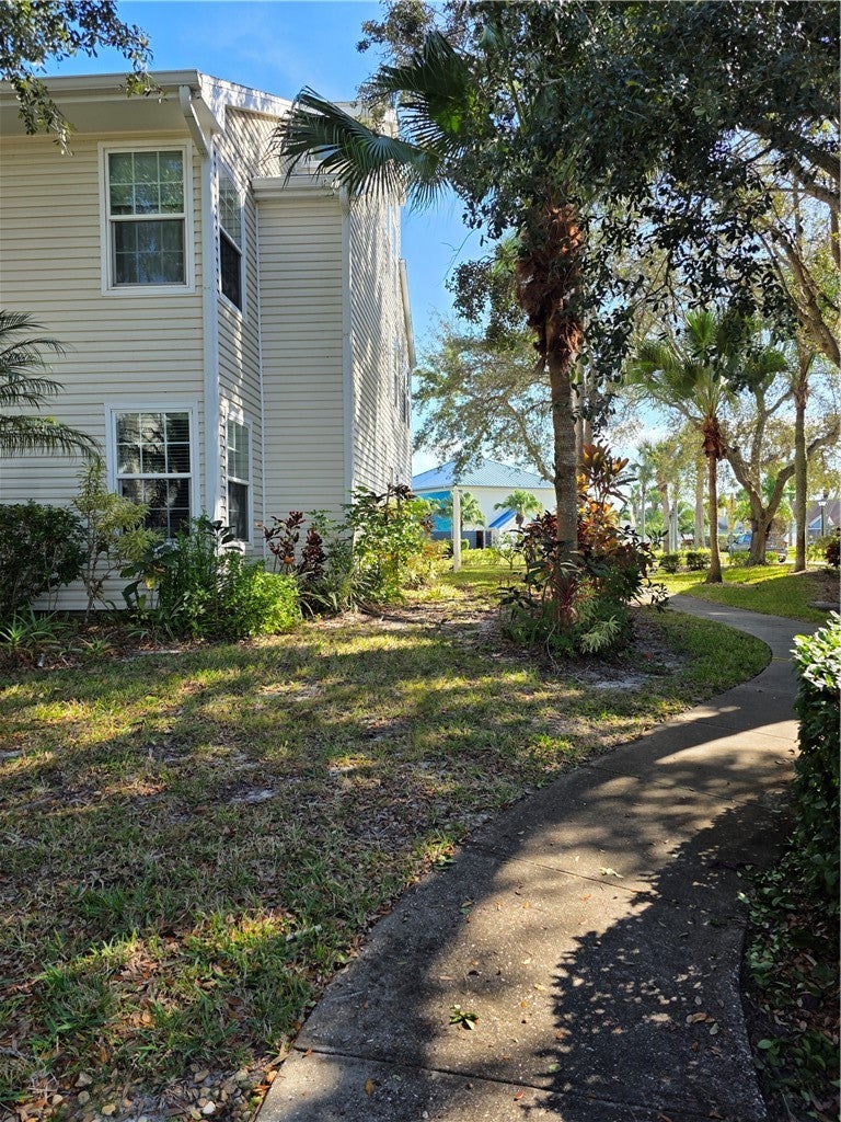 View of side of property with a lawn