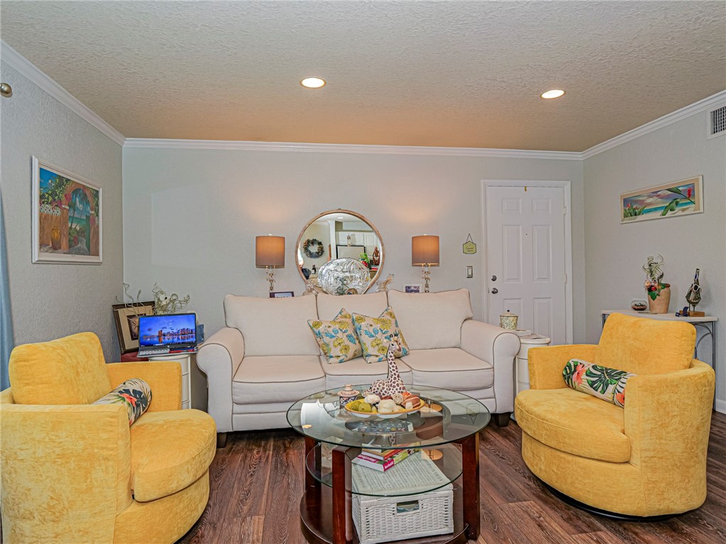 Living area with wood finished floors, a textured