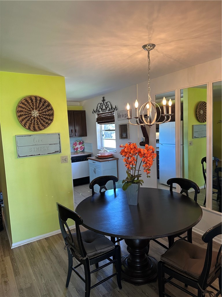 Dining area featuring wood-finish flooring, a cont