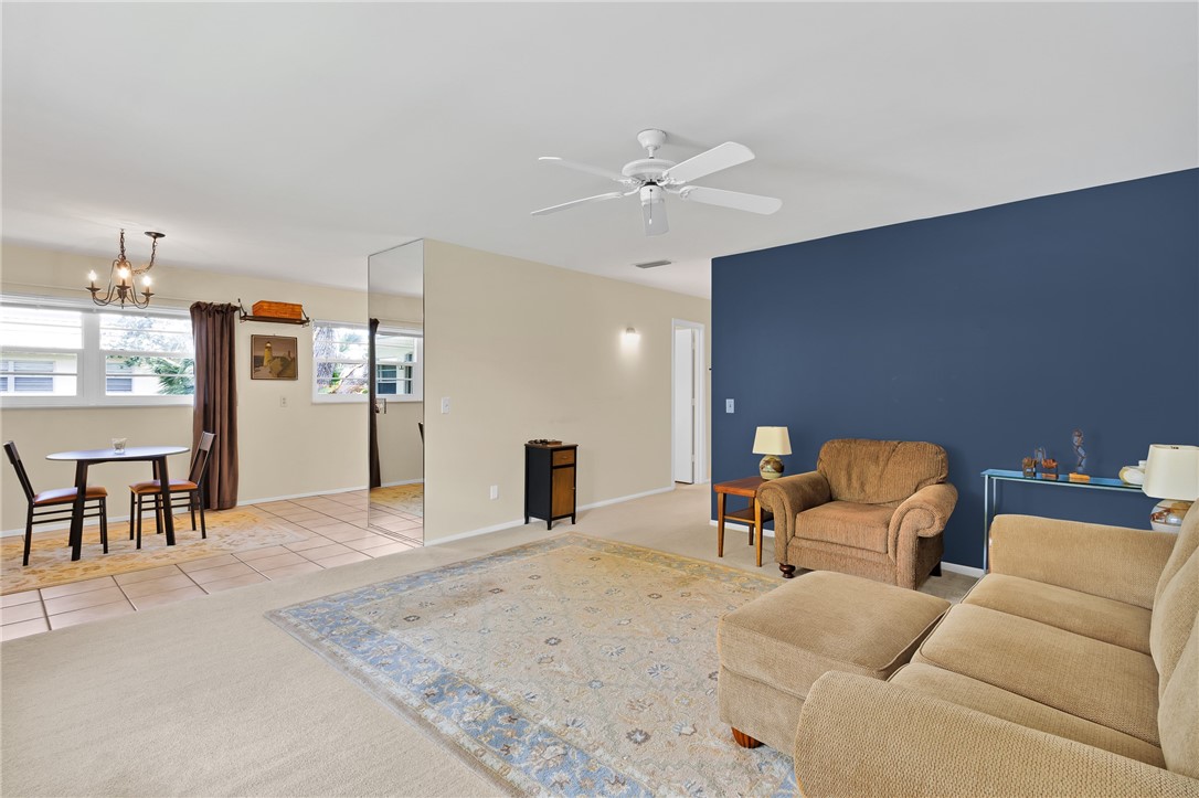 Carpeted living area with a dark blue accent wall,
