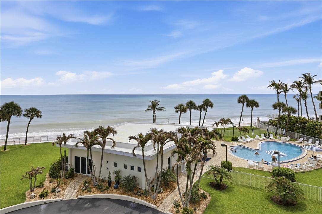 Oceanfront setting featuring a resort-style swimmi