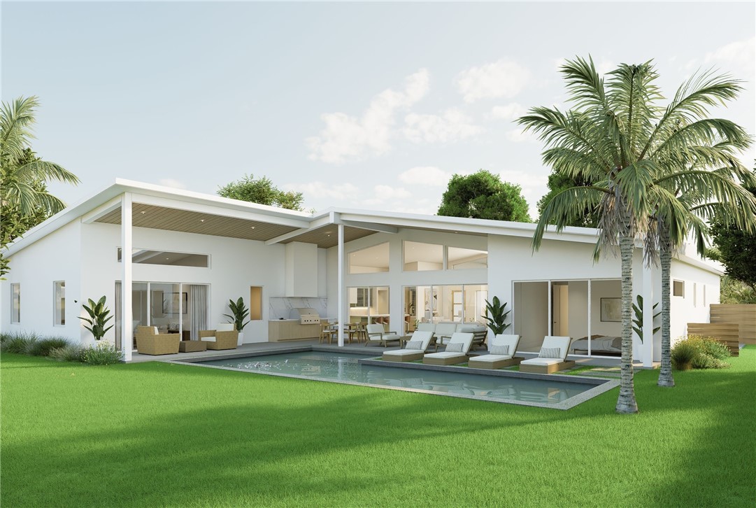 Rear view of house with an outdoor pool, a patio a
