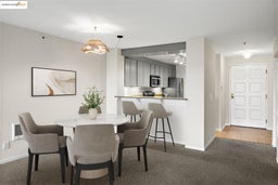Dining room featuring dark colored carpet and dark tile patterned floors