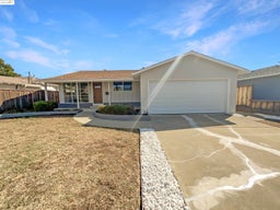 Single story home featuring driveway, roof with shingles, and a garage