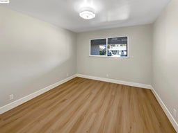 Empty room with baseboards and light wood finished floors