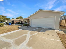 Single story home with driveway, stucco siding, and a garage