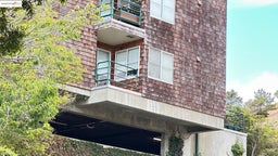View of side of home with a balcony