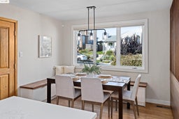 Dining area with wood finished floors and a chandelier
