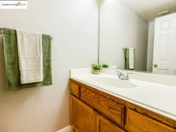 Bathroom featuring vanity and a textured wall