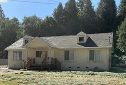 View of front of property featuring crawl space, a shingled roof, and stucco siding