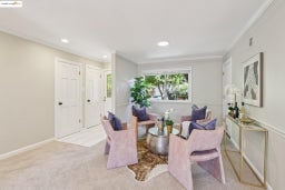 Living area featuring carpet floors, ornamental molding, recessed lighting, and tile patterned floors