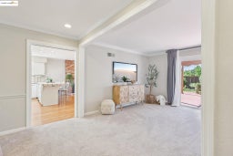 Sitting room featuring light carpet and crown molding