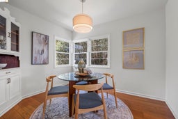 Dining room with dark wood finished floors and baseboards