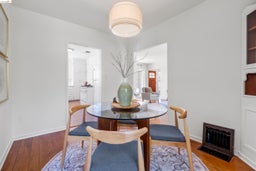 Dining area with wood finished floors and heating unit