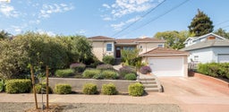 Mediterranean / spanish-style house with a tile roof, stucco siding, a chimney, and driveway