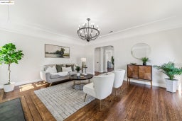 Living room featuring arched walkways, dark wood-style floors, and a chandelier