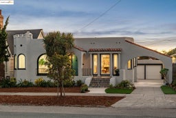 Mediterranean / spanish-style home featuring driveway, stucco siding, and a tile roof