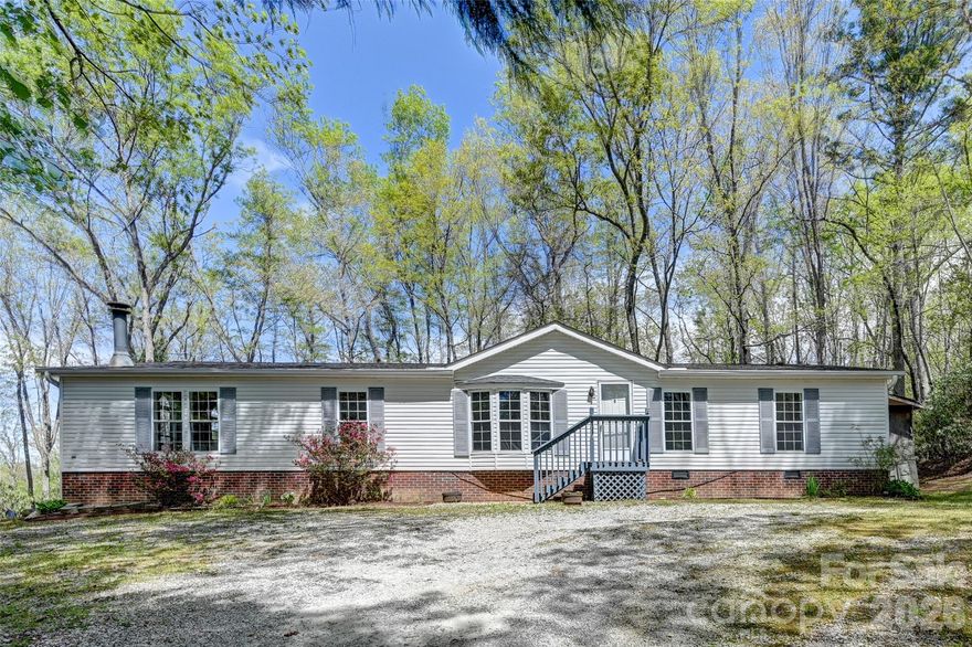 Only 4 Miles out of downtown Hendersonville, but it feels very remote and quiet. 
This 1995 3/2 manufactured doublewide is a lovely place to call home. A wood-burning fireplace in the living room and lots of light. This home has great space with a large kitchen, laundry room, and extra den space. A nice .78 acre lot surrounded by trees. A Standard 1 yr 2-10 Home Warranty included!!! Home is only 3 miles from Walmart and 1-26. Come See this. home!