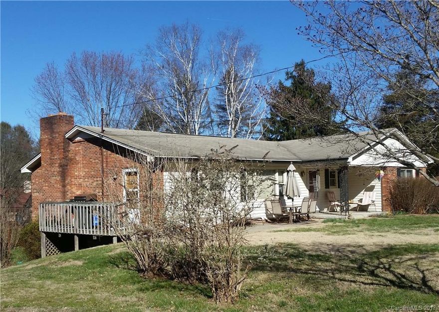 A dream location only 35 minutes to Asheville & 10 to downtown Waynesville. Paved frontage on a dead end street in an excellent neighborhood. 4BD (plus bonus rm) /3BA brick home on .36 ac lot with downstairs apartment with separate entrance & 1276 sq ft of garage & shop area. Excellent flat yard with plenty of parking. Plant window in kitchen, on-demand hot water heater, thermopane windows, new laminate flooring. 2 fireplaces. Heat pump w/air. 12x24 outdoor shop with electric.