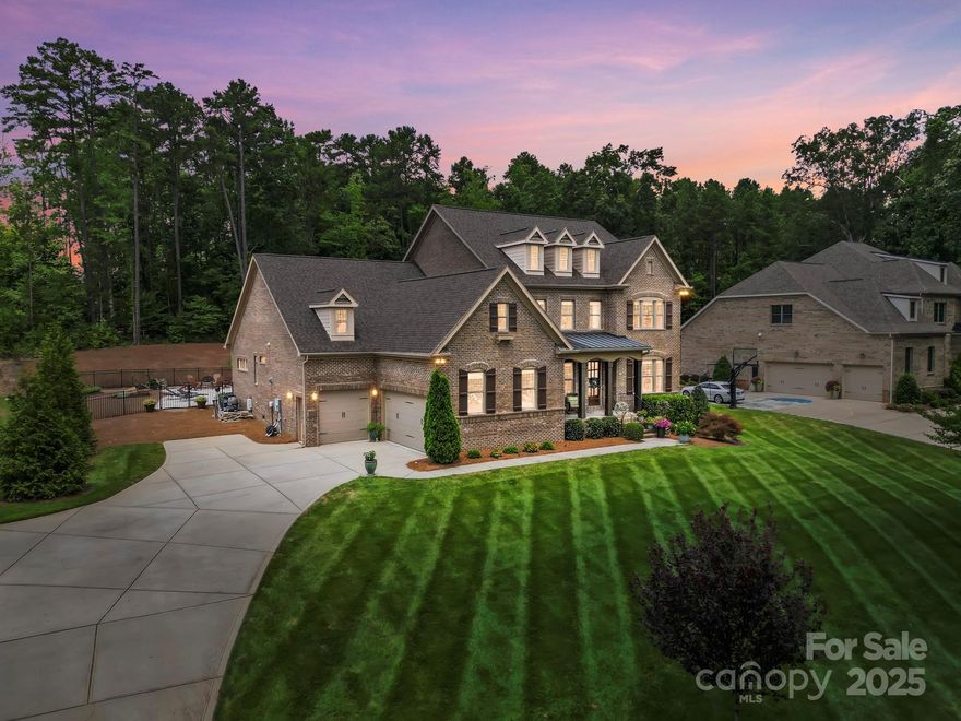 Nestled within an exclusive gated sanctuary, this magnificent five-bedroom residence epitomizes sophisticated living with its thoughtfully curated amenities. The primary suite graces the main level, featuring a sumptuous ensuite with both stand-up shower and soaking tub for ultimate relaxation. The heart of the home showcases a spacious kitchen adorned with quartz countertops, a commanding island, dual ovens, and butler's pantry—a culinary enthusiast's dream. Upstairs, generously proportioned bedrooms boast walk-in closets and convenient jack-and-jill bathrooms. Step outside to discover your private oasis: a covered porch with pergola overlooks a fenced yard harboring an in-ground pool and hot tub, complete with fountain and color-changing lights plus beach-style entry. Community privileges include additional pool and tennis courts, while shopping and dining establishments await nearby for your convenience.