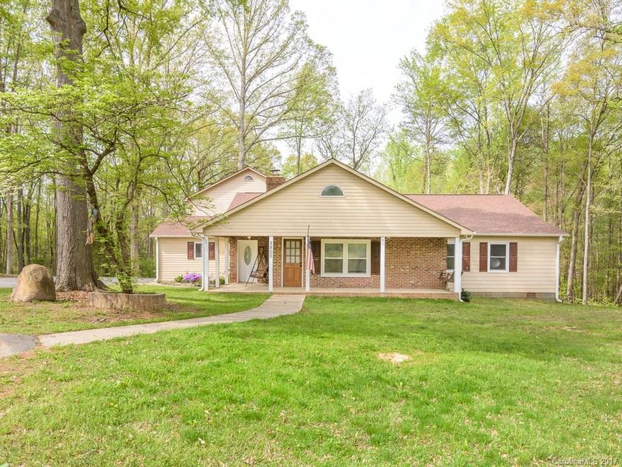 Unique open airy country home on 1.80 acres within minutes of Lake Wylie.  Spacious kitchen and living room with tray ceiling and stone fireplace.  Three large bedrooms (2 masters) and three baths on main level.  Two bedroom, large bonus room and attic storage area on upper level.  Two car detached garage with workshop.  Space for gardening, pets and country fun !