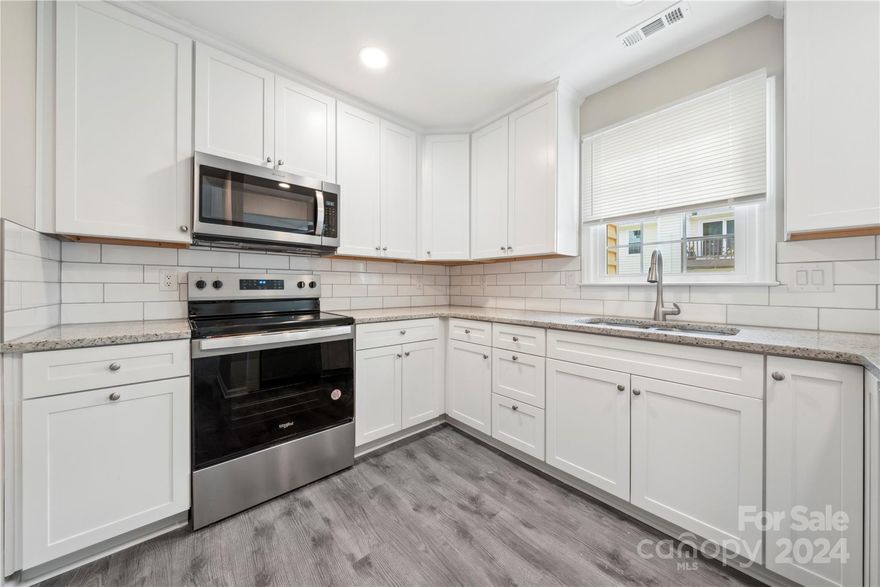 Discover your Urban Oasis! Step into this stunning, upgraded 2-bedroom, 2-bath single-story condo, nestled in the heart of  up-and-coming Lower South End (LoSo)! This exquisite home boasts NEW dual-paned windows, fresh paint, new s/s appliances, designer fixtures, & brand new Luxury Vinyl Plank flooring that flows seamlessly throughout the space, offering both durability & a touch of elegance.  Kitchen is a chef's dream featuring custom cabinetry & sleek granite countertops-perfect for preparing gourmet meals and/or casual breakfasts. Both bathrooms are adorned with custom tile surrounds. The primary bath, takes luxury to the next level with a custom glass shower door, making every shower feel like a retreat! Relax in the inviting living room by the cozy, wood burning fireplace-the ideal spot for unwinding after a long day or for entertaining guests. This condo offers a perfect blend of comfort and style! Don't miss your chance to own a piece of Lower South End's vibrant future!