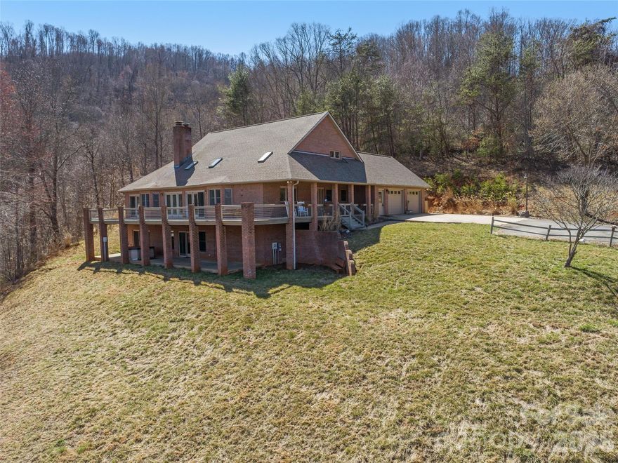Private Mountain Estate | 4.75 Acres | 5,258 Sq. Ft. | Year-Round Views

Discover a rare mountain retreat where privacy, comfort, and panoramic beauty converge. Set on 4.75 serene acres, this exceptional 4-bedroom, 3.5-bath residence offers 5,258 square feet of thoughtfully designed living space framed by breathtaking, year-round mountain views.

The light-filled interior is enhanced by expansive skylights and a wall of French doors in the Great Room, seamlessly connecting indoor elegance with outdoor living. Step onto the expansive deck—half covered for all-season enjoyment—perfect for morning coffee, sunset gatherings, or quiet reflection above the rolling landscape.

Designed for both relaxation and entertaining, the home features a cozy Appalachian wood stove, a dedicated billiard room, and a private office ideal for remote work. The spacious primary suite serves as a true retreat with dual walk-in closets, a spa-inspired bath, and direct deck access.

The kitchen showcases stainless steel appliances and a newer butcher block countertop, complemented by a second full kitchen offering exceptional flexibility for guests, multi-generational living, or investment potential.

Outdoors, the property continues to impress with a paved driveway, double garage, rolling hill yard, established garden space nourished by spring water, and a welcoming fire pit area designed for evenings under the stars. Located in a quiet, unrestricted setting, this estate offers rare freedom and opportunity.

A refined mountain sanctuary combining space, serenity, and versatility—an extraordinary opportunity to live beautifully without compromise.