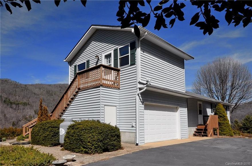 2Bdrm/2Ba Contemporary Home featuring one level living, ample decking to entertain, plus additional 288 sqft rm above garage.  This could be your Den, Workout Rm/Additional Bdrm w/ Private entrance. A beautiful walkway from the back yard leads to your creek & waterfalls.  Also features an observation deck to enjoy the spectacular year round mountain views.  3500" elevation to enjoy mountain breezes! Easy access w/paved roads.  Sold completely furnished!!  Located between Waynesville and Cherokee