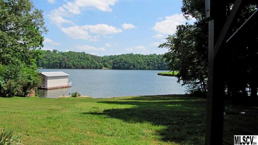 Enjoy entertaining in this 3/2.5 brick ranch with basement overlooking main channel of Lake Hickory. All rooms are spacious. Kitchen offers tile floor, white cabinets, laundry closet, and lots of sunny windows. Great room has shiny hardwood floors, beamed ceiling, gas logs and entrance to sunroom to enjoy lake views. Sunroom is heated/cooled or open the windows. Dining room is just off kitchen. Main level master. Heated basement offers bdrm, full bath, den. Unheated has large work space with shelving, cabinetry and single garage. Large backyard with plenty of sunny garden space. Dockable waterfront is walled with concrete. Big panoramic views. Range, fridge, dishwasher, washer/dryer convey. Located in Alexander county on the north side of the lake with 99' water frontage. 3 miles to grocery store and drug. 6 miles to Hickory city amenities.