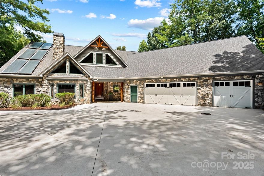 Spectacular lakefront custom home, built by Jeff Keever, on a 3+ acre point lot in desirable River Bend subdivision on Lake Hickory. With ±924 feet of shoreline, this unique property encompasses a floating dock, natural beach & panoramic lake sunrise/sunset views. The grounds include a greenhouse & organic raised-bed gardens. The open floor plan features a gourmet kitchen w/ granite counters, dual apron sinks, stainless steel appliances & an integrated refrigerator. The great room boasts 22 ft cathedral ceilings, a gas log fireplace, & a hand-hewn mantle. The main level oversized primary suite includes a hand-laid stone shower room, jacuzzi tub & custom walk-in closet. A den, office, screened-in porch with gas fireplace, and additional bedroom offer more main level living space. 2nd level offers 2 additional bedrooms, Jack & Jill bath, and large bonus room. Extras include: heated lap pool, sauna, exercise room, 3 car garage, & bonus basement level garage.